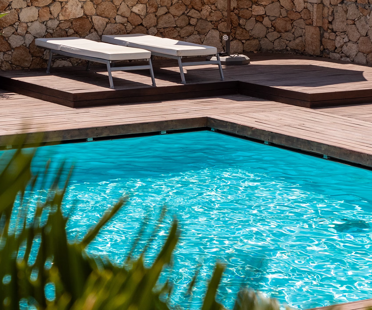 A pool with a blue water surface, in a residential pool environment.